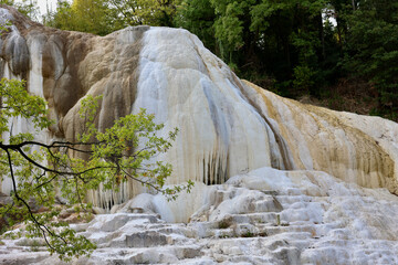 Bagni San Filippo is a small hot spring containing calcium carbonate deposits, which form white...