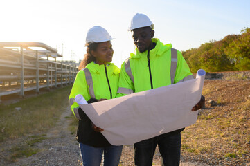 Male and female engineers check the drawing system inspection with the real pipe system of the new...