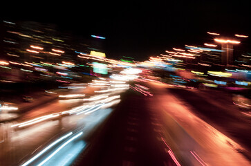 Motion blur of cars at a night intersection. Bright abstract background for wallpaper