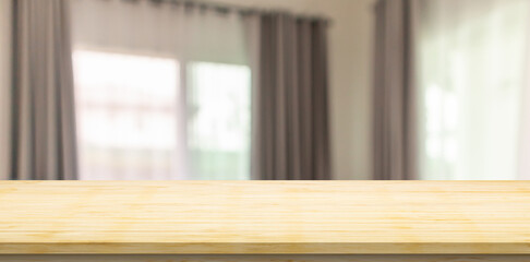 Empty wood table top with blur room interior with window curtain background