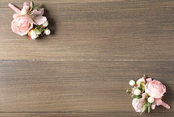 Beautiful boutonnieres on wooden background, flat lay. Space for text