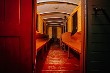 Riga, Latvia - February 16, 2024 - interior of an old train car with wooden benches and a curved...