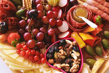 Antipasto platter with meat, chease, fruits, vegetables and nuts. Appetizer, catering food concept - 741618920