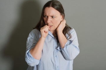  Studio portrait of scared woman biting her nails, fear and insecurities - 741618972