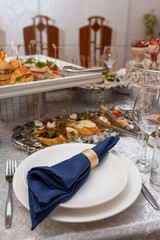 Elegant table setting with blue napkin and silverware