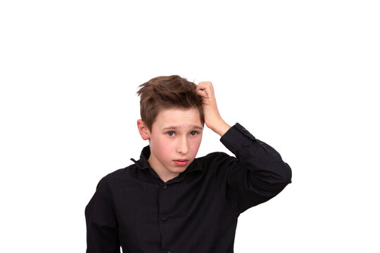 I have no idea. Portrait of a confused boy, feeling insecure, not knowing the answer. Thoughtful teenager touches his head with his hand, white background with a space to copy