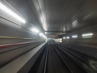 Foto op Plexiglas fast moving subway tunnel metro train with blurred motion © Marco