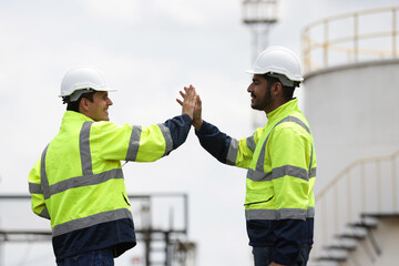 Railway engineer with green safety jacket high five together for job successful