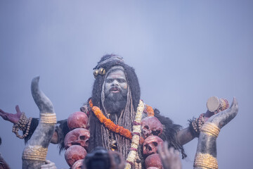 Masan Holi, Portrait of an male artist act as lord shiv with dry ash on face and body also in air...