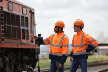 Rail engineer or technician working with blue print drawing at site maintenance service train, train transportation 