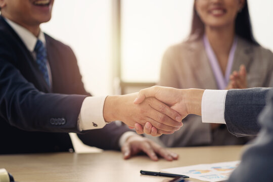 Businessmen handshake to reach an agreement and congratulate each other on doing business together. Success achieves business goals