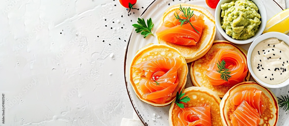 Aufkleber Mini blini pancakes with soft cheese cold smoked salmon and guacamole. with copy space image. Place for adding text or design
