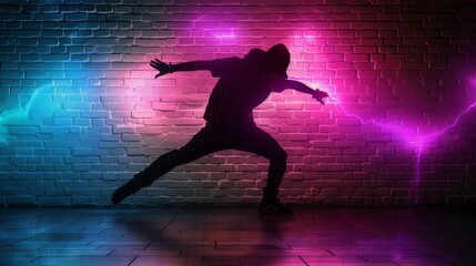 A dancer strikes a dynamic pose, silhouetted against a brick wall bathed in vibrant neon lights, creating an energetic urban scene.