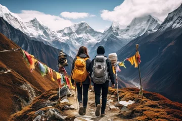 Fotobehang Trekking couple on mountain trail with prayer flags. Adventure and travel. © Postproduction
