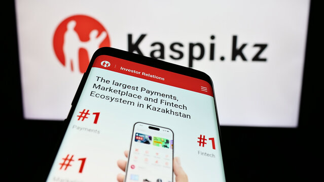 Stuttgart, Germany - 02-13-2024: Smartphone with webpage of Kazakh financial services company Kaspi.kz in front of business logo. Focus on top-left of phone display.