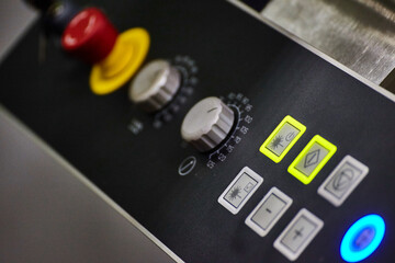 Modern Industrial Control Panel with Rotary Dials and Backlit Buttons