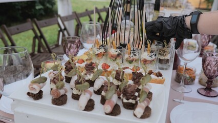 Beautiful delicious food and snacks on the festive table in the restaurant. Business lunch. A beautiful festive table covered with a variety of food. Food and drinks on the festive table.