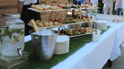 Buffet indoors. Catering business waiter. Catering on a banquet table with appetizers-canapes in a restaurant or hotel. Snacks on the table, catering concept.