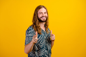Photo of good mood funky guy wear print shirt pointing two fingers you isolated yellow color...