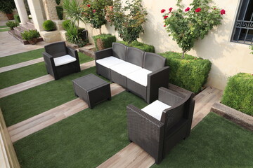 Modern garden furniture set of rattan inside the patio of the house