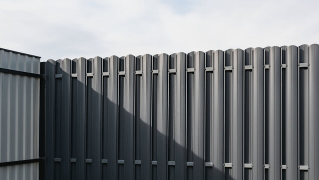 New fence made of dark-colored metal profile