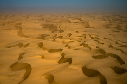 Aerial view of yellow sand dunes in the Namib Desert, Namibia.