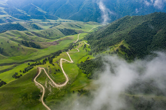 Aerial view of beautiful mountain landscape with road crossing the valley in Karachay-Cherkess, Elbrus, Khabaz, Kebardino Balkaria, Caucasus, Russia.