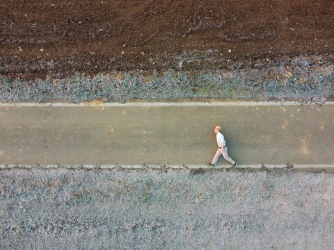 Aerial view of a person laying down on the ground inside pipe, Pozzolo, Formigaro, Piedmont, Italy.