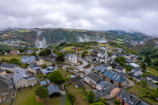 Aerial drone view of Bourscheid village in countryside of Luxembourg on cloudy day.