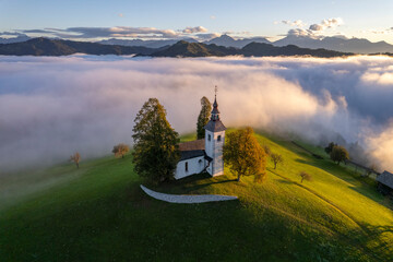 Aerial drone view of the beautiful hilltop church of Sveti Tomaz (Saint Thomas) Skofja loka, Slovenia.