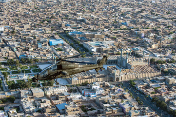 Herat, Afghanistan - 07 June 2014: Aerial view of an A129 'MANGUSTA' helicopter of the Italian Army with anti-tank functions, Masjid i Jami Mosque in Herat, Afghanistan.
