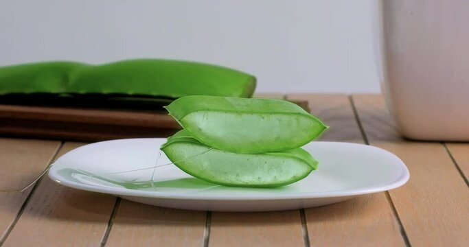  video of aloe vera being cut and chopped on wooden chopping board and washed in water
