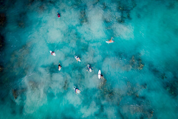 Aerial drone view of surfers catching waves at Trigg beach, Western Australia, Australia.