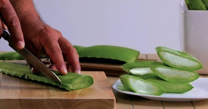 video of aloe vera being cut and chopped on chopping board
