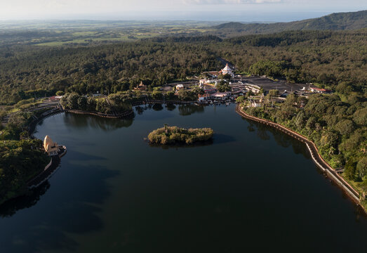 Aerial drone view of Ganga Talao, a Hindu pilgrimage site with temples and crater lake at early morning, Grand Bassin, Savanne, Mauritius.
