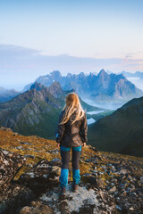 Woman solo traveler hiking in Norway exploring mountains of Lofoten islands tourist traveling outdoor alone healthy lifestyle summer vacations adventure extreme tour - obrazy, fototapety, plakaty