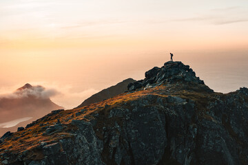 Climbing adventures summer vacations outdoor Man traveler on mountain summit traveling in Norway active tourism hiking outdoor healthy lifestyle freedom concept tourist exploring Lofoten islands - 741699597