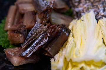 View of the half-dried saury with napa cabbage and seaweed