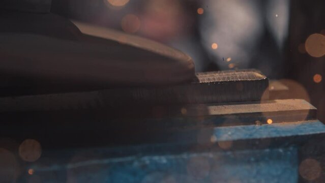 Witness the mesmerizing dance of glowing sparks as an angle grinder works on metal in stunning 4K slow motion.