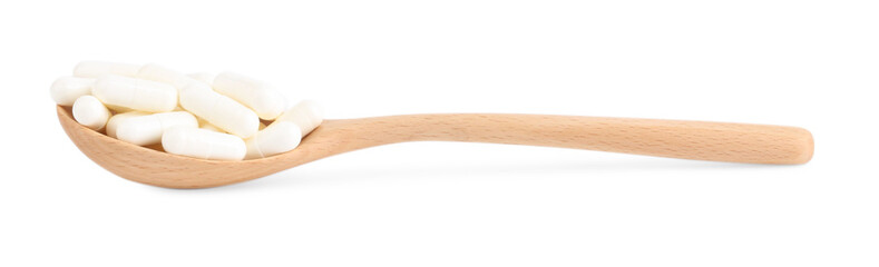 Fototapeta na wymiar Vitamin capsules in wooden spoon isolated on white
