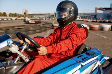 Concentrated karting pilot ready to start championship in outdoor go-karting circuit © Nomad_Soul