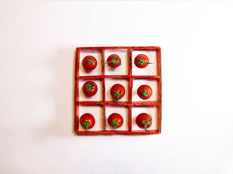 Overhead view of an arrangement of nine tomatoes in a grid