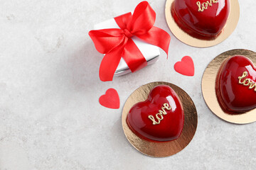 Obraz na płótnie Canvas St. Valentine's Day. Delicious heart shaped cakes and gift on light table, flat lay. Space for text