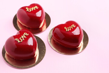 Obraz na płótnie Canvas St. Valentine's Day. Delicious heart shaped cakes on light pink background, closeup