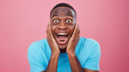 close-up of a young man with a joyful and surprised expression, hands on his cheeks, against a vibrant pink background. - obrazy, fototapety, plakaty