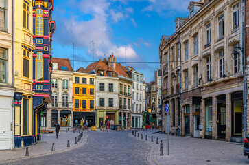Vieux Lille old town quarter with empty narrow cobblestone street, paving stone square with old...