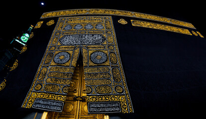 The golden doors of the Holy Kaaba closeup, covered with Kiswah. Massive lock on the doors....