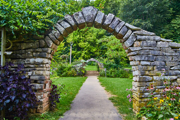 Rustic Stone Arches in Serene Garden Pathway