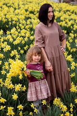 Daughter gives flowers to mum