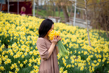Fototapeta premium Portrait of cute girl holding flowers at home,Christchurch,Canterbury,New Zealand